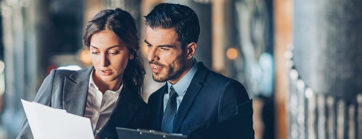 business people reviewing umbrella liability insurance reports