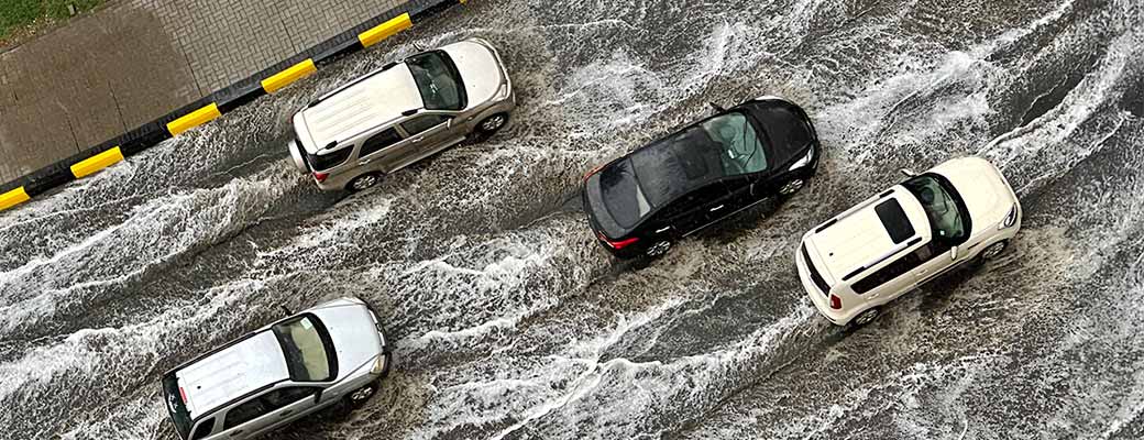 cars driving on flooded road 