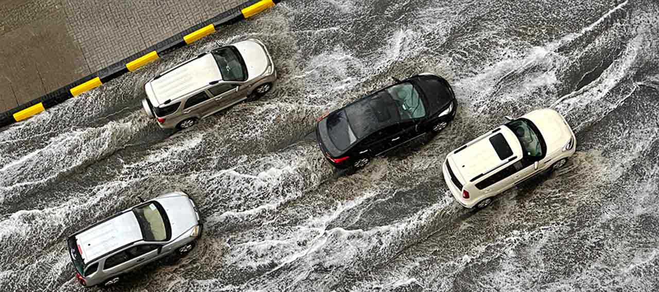 cars driving on flooded road 