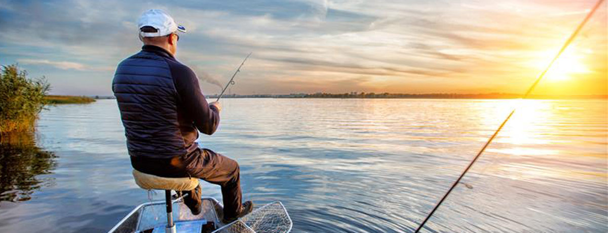 man fishing off boat