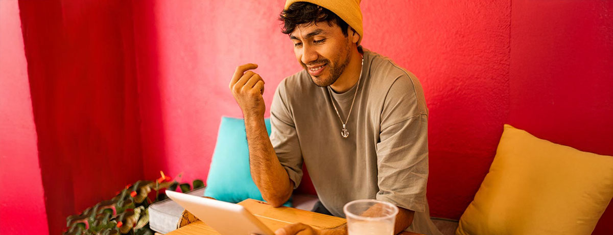 man in beanie working on laptop